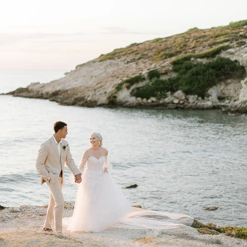 bride and groom walking at sunset in Crete by the see