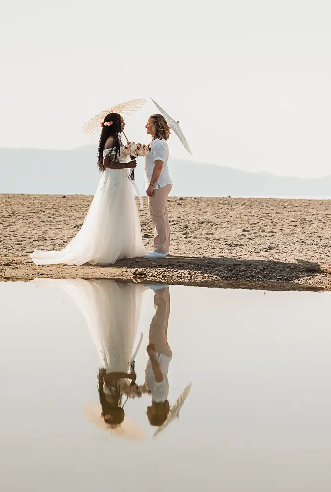 a reflection photo with the couple facing each other, at the beach in Chania Crete