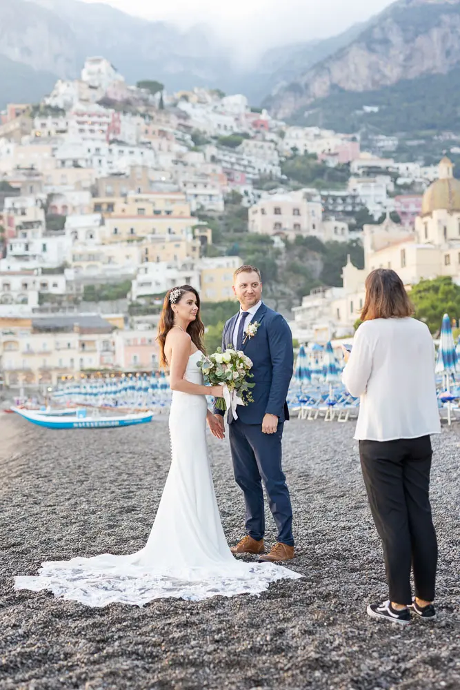 The couple and celebrant at the beach, a public location at Amalfi Coast