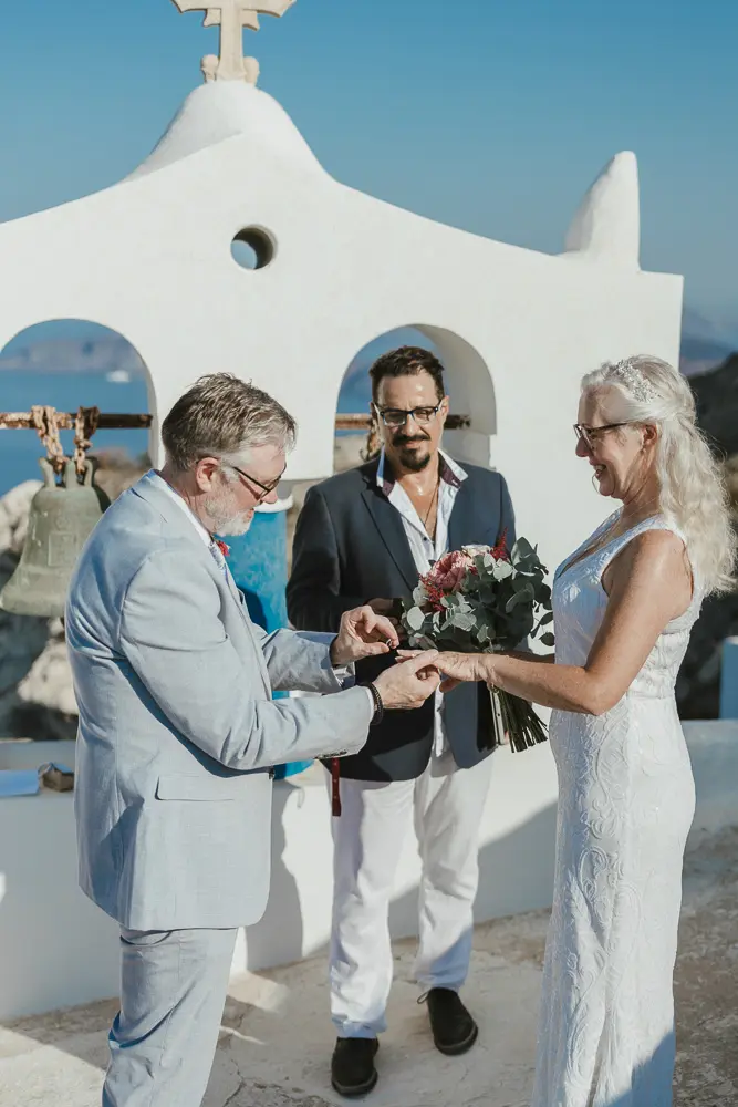bride and groom celebrating in Santorini at a public location