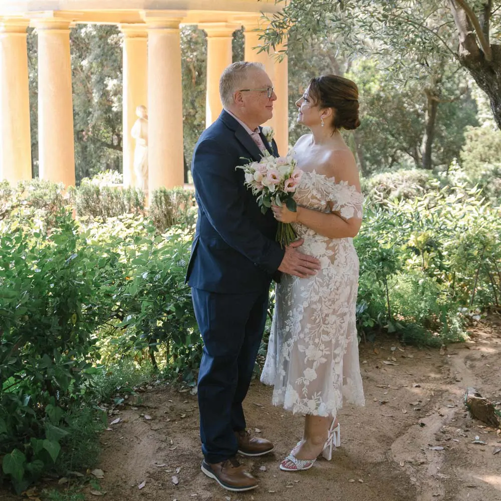 The couple facing each other after their vows renewal ceremony in Barcelona park