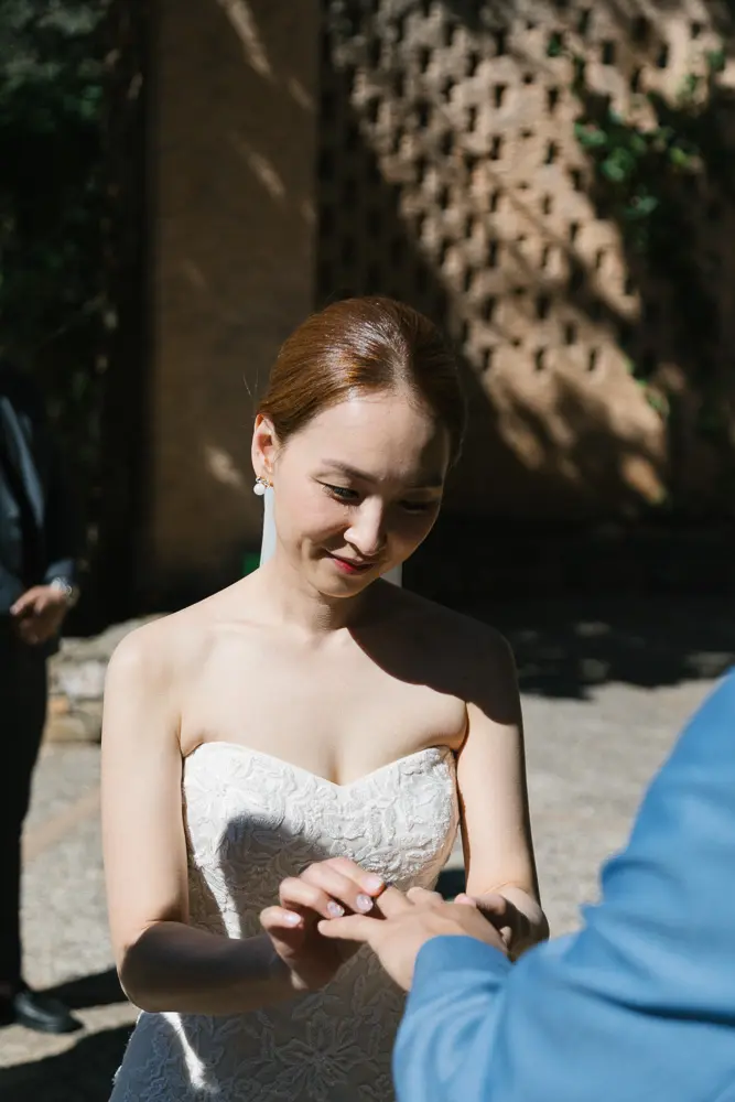 The bride slides th ering to the groom