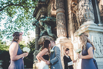 Smily couple renewing vows in front of Notre Dame cathedral in Paris