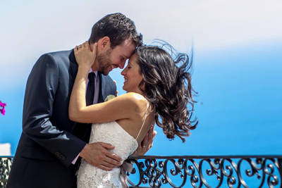 Couple kissing after ceremony elopement in front of the sea, Greece Couple kissing after ceremony elopement in front of the sea, Greece