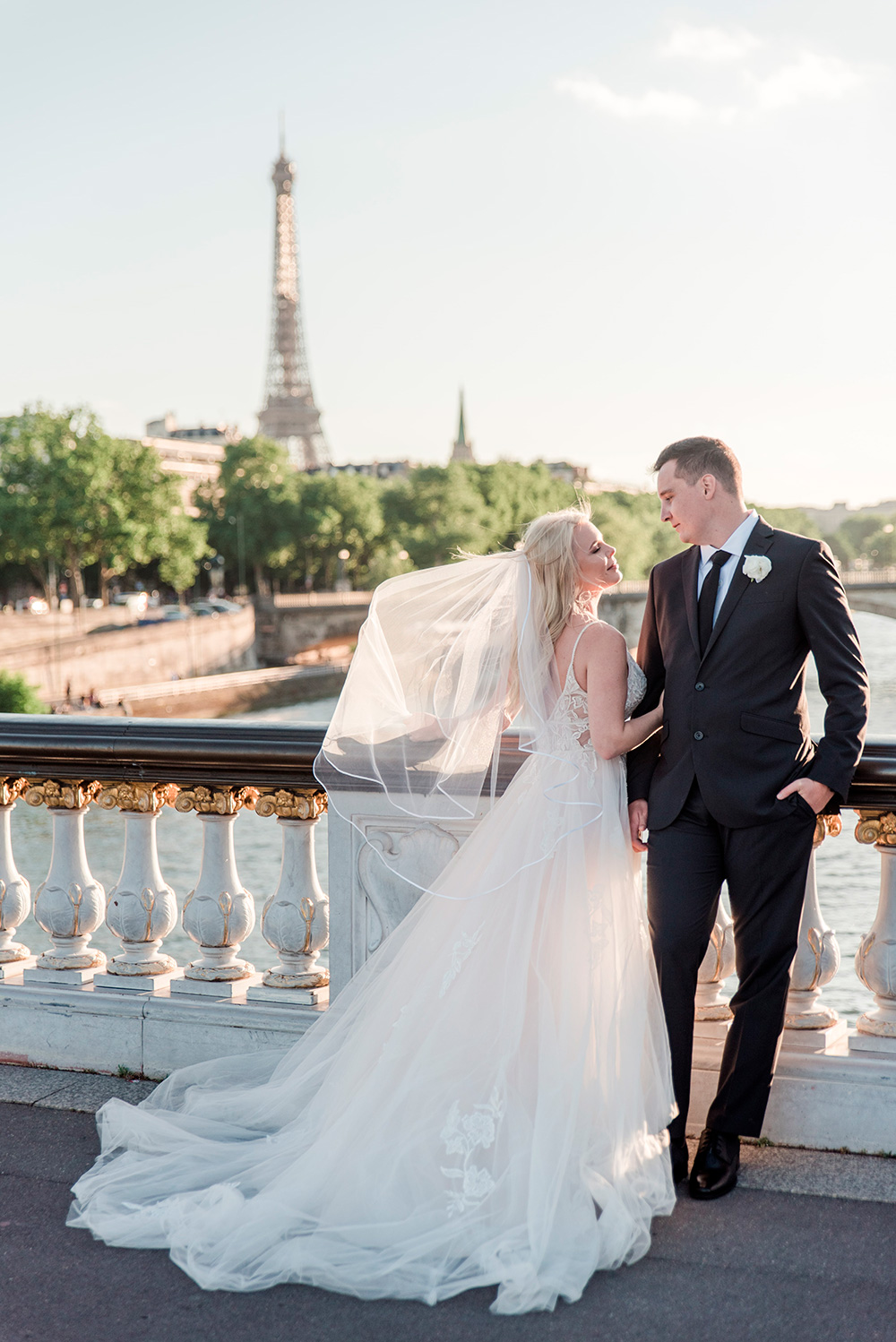 bride and groom looking at each other on the Alexandre III bridge