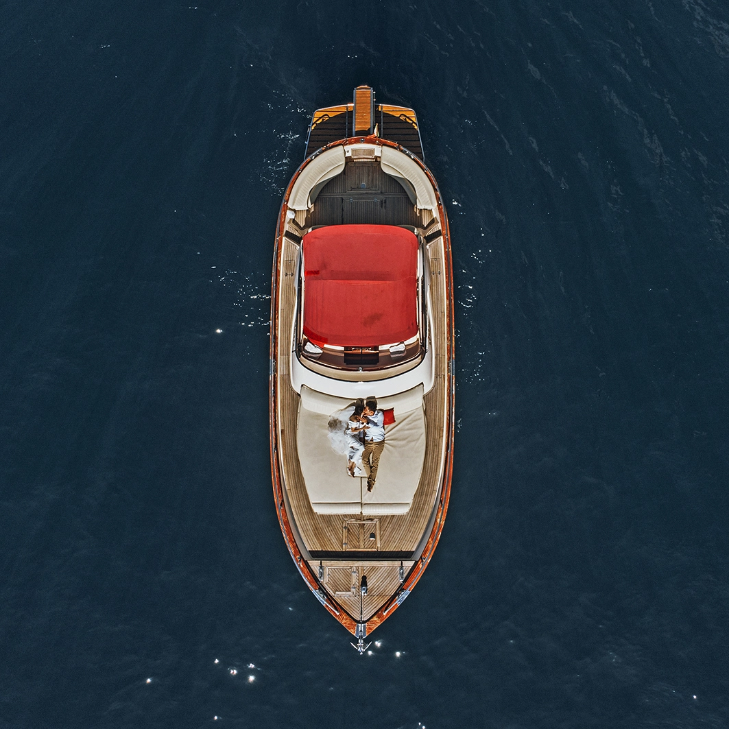 A view of the couple from a drone on a boat in Sicily sea