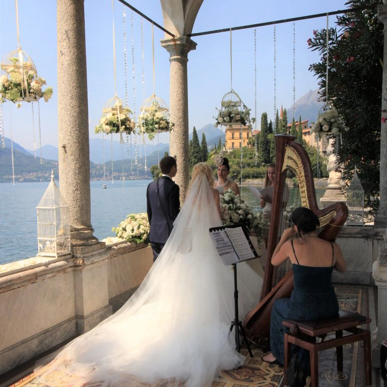 ceremony on a balcony above lake como, in the background the moutains