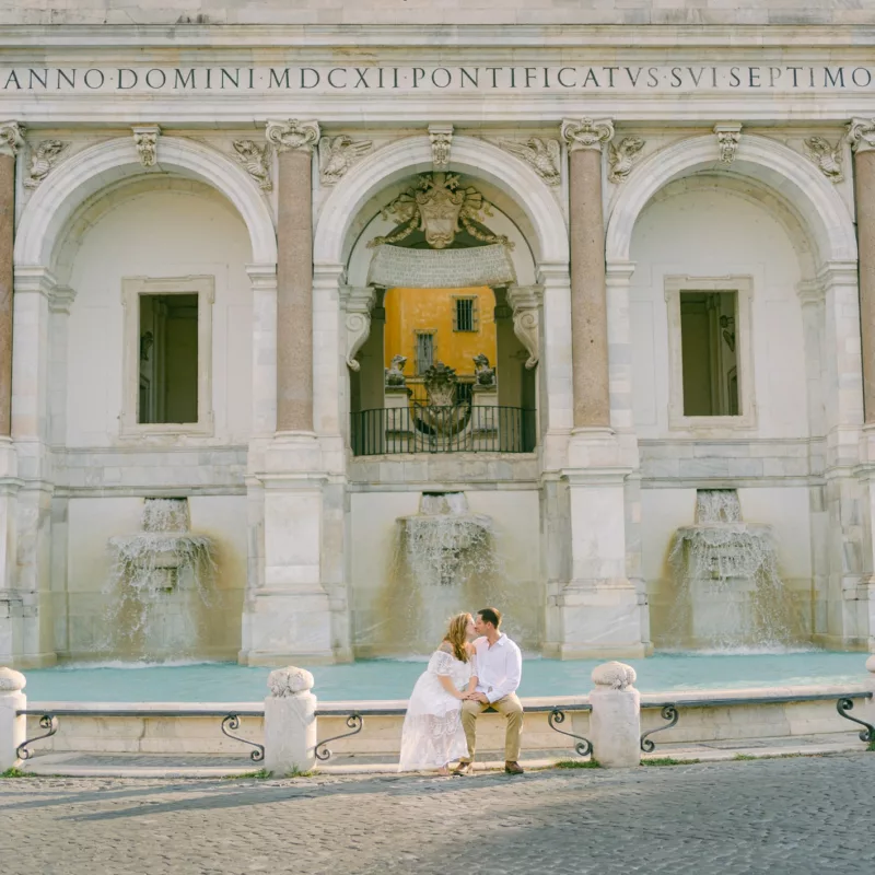 vibrant colors for this couple on a bench after their elopement in Rome