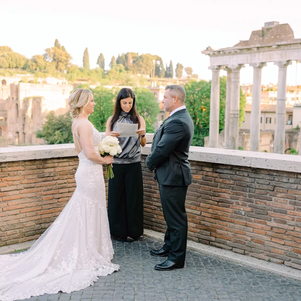 The couple facing each other in Roman forum before the ceremony