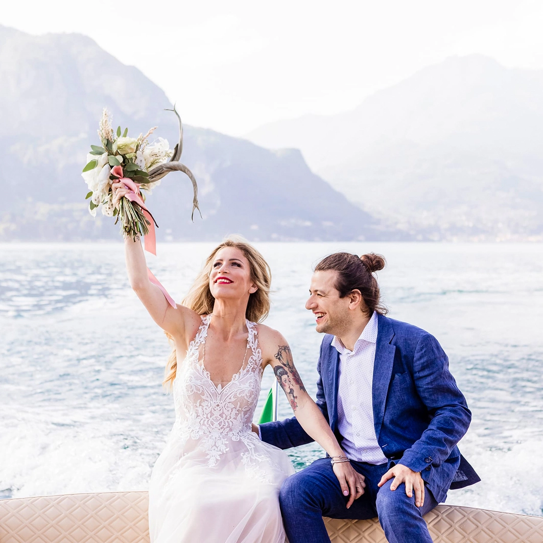 bride and groom on a boat at Lake como in Italy