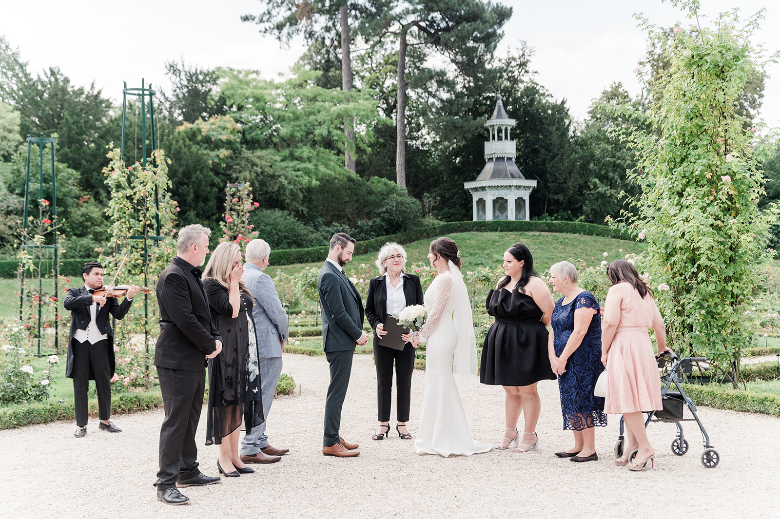 All the family gathered around bride and groom at Parc de bagatelle for the ceremony