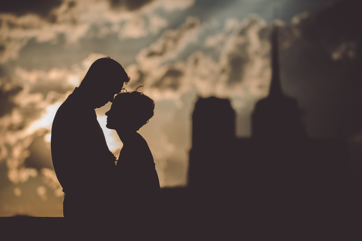 The silhouette of bride and groom at the sunset