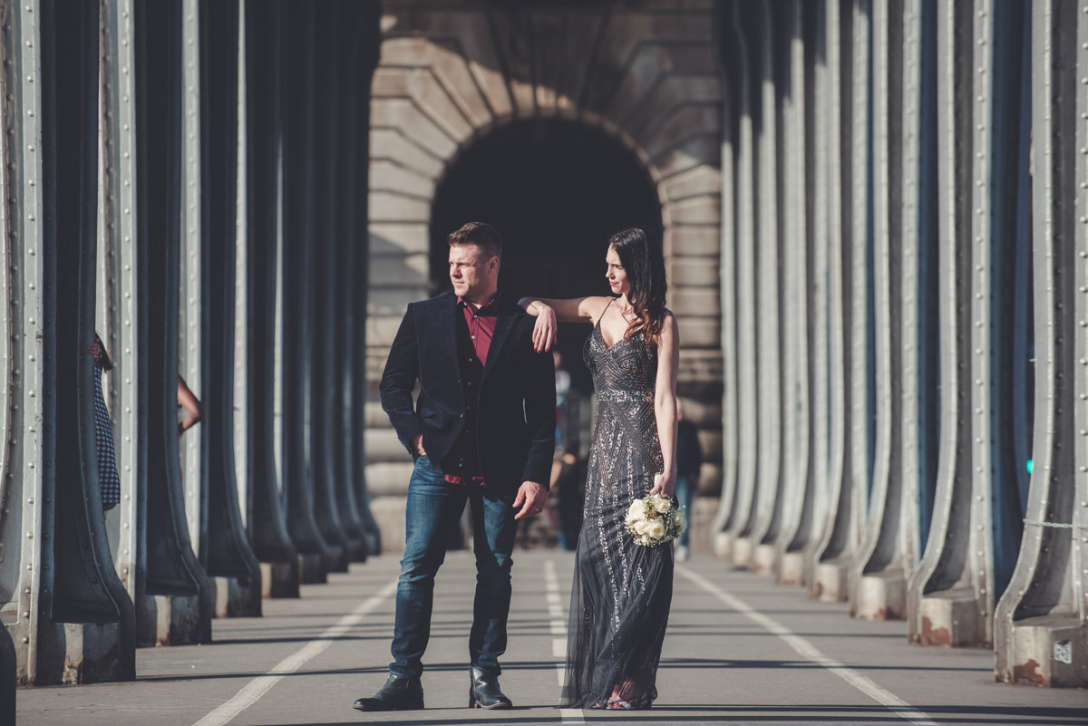 The couple posing under the Bir Hakeim bridge