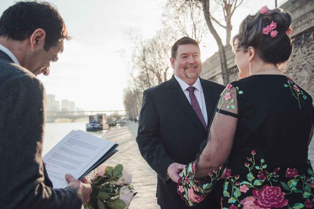 The groom is smiling during his speech of vows