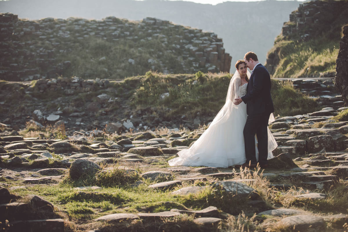 Couple on the beach with the cliff as a background