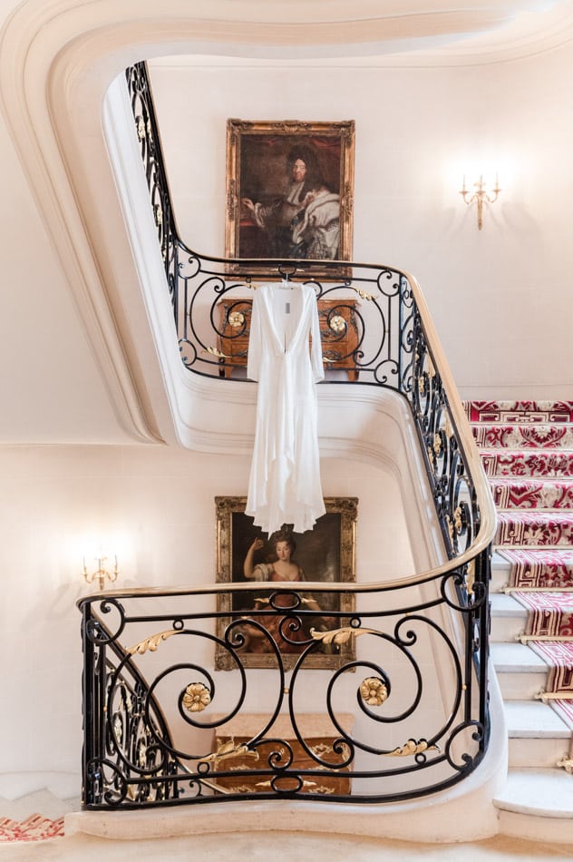 The wedding dress hanged up in a vintage stair