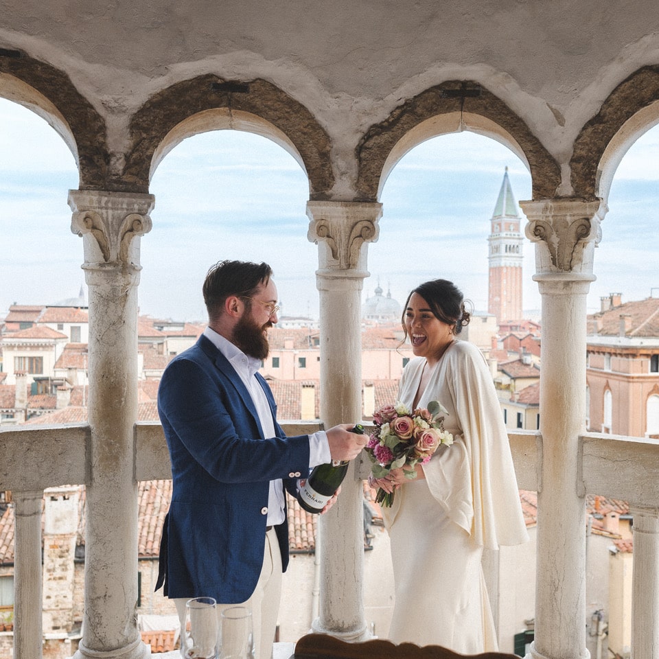 The couple at the top of a tower in venice overlooking the canals