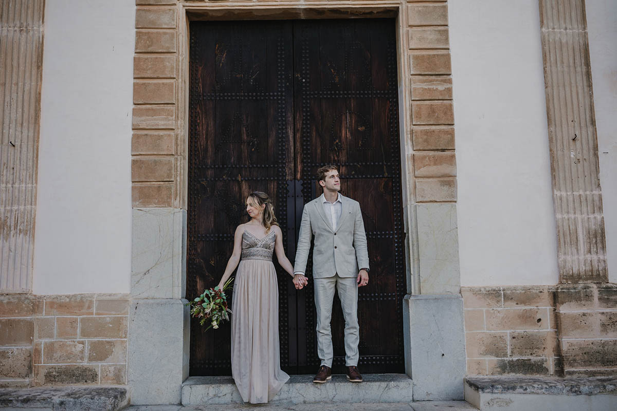 bride and groom for the traditional picture in front of a typical door