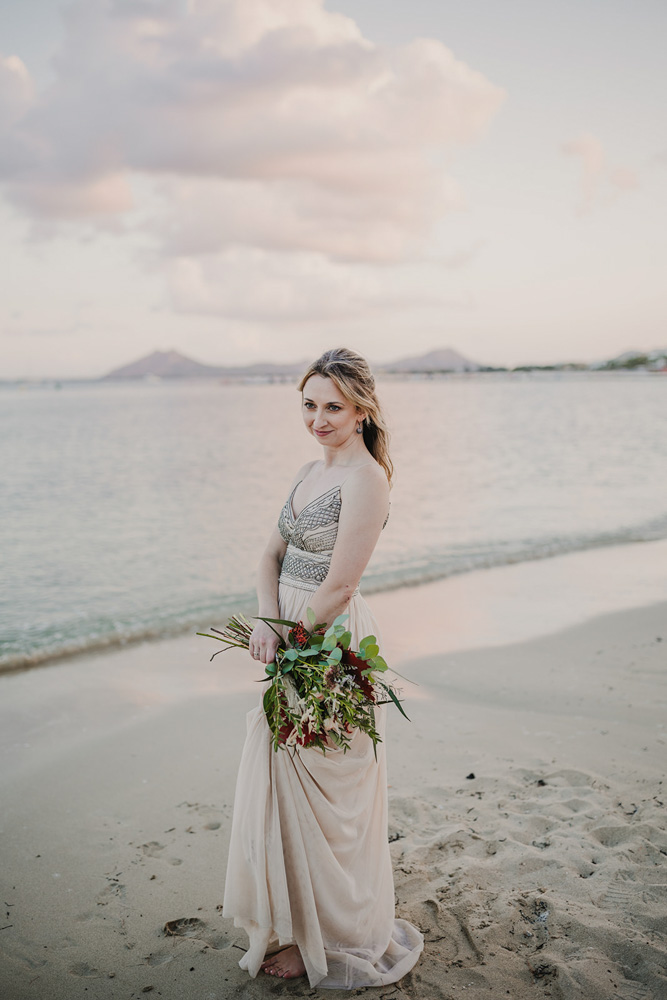 The bride with her bouquet on the beach