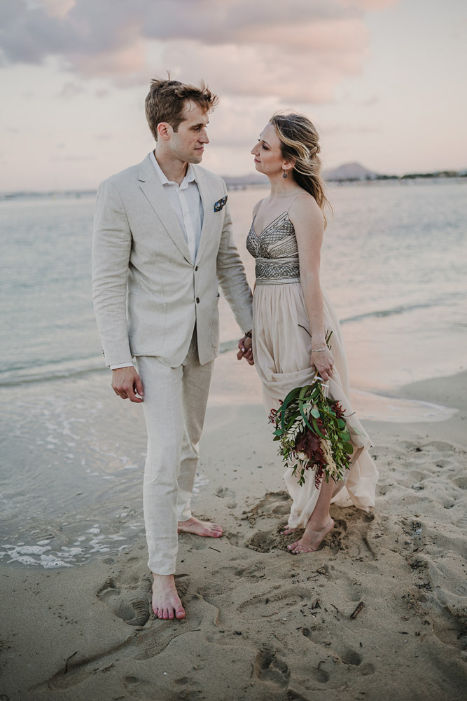 The couple posing at sunset on the beach