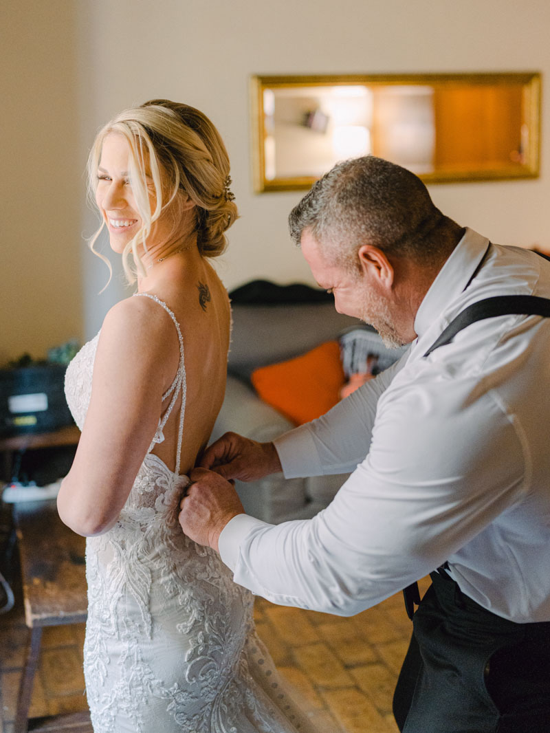 the groom helps his future wife to get ready