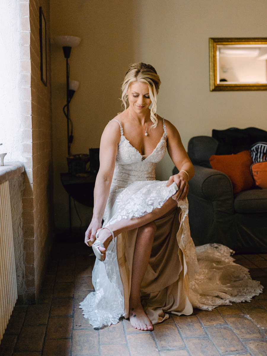 a delicate lightinf for the bride putting her shoes in front of the window