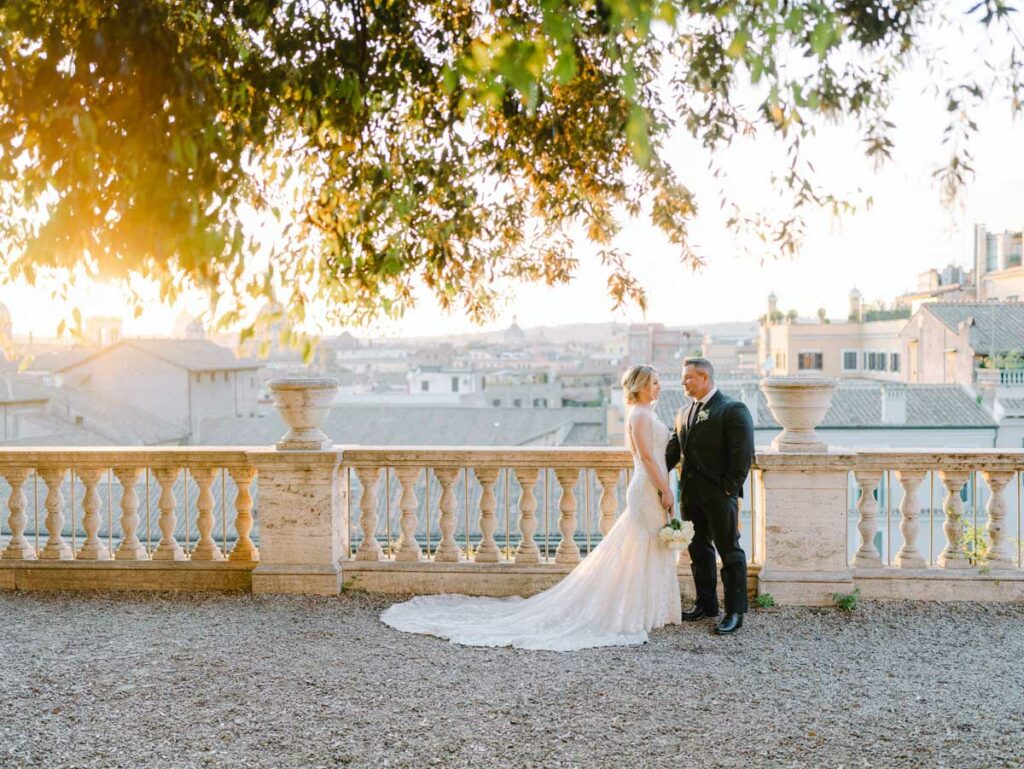bride and groom at sunset at a balcony above ROME
