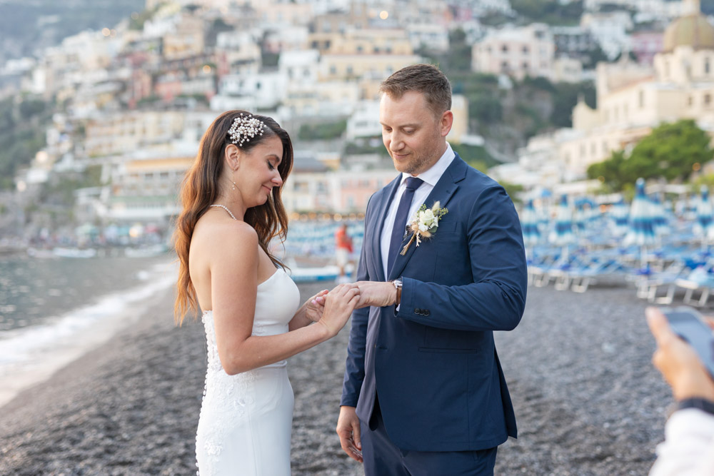 the bride slides the ring to the groom