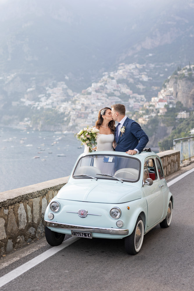 The couple in the vintage Fiat 500 car