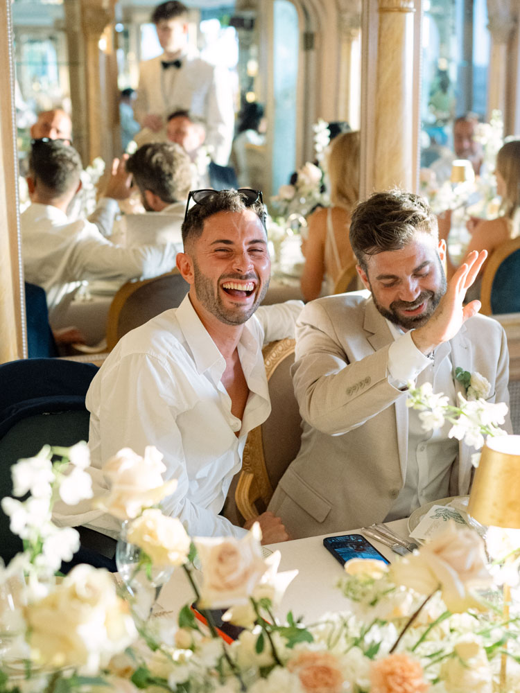 The bestman laughing with the groom