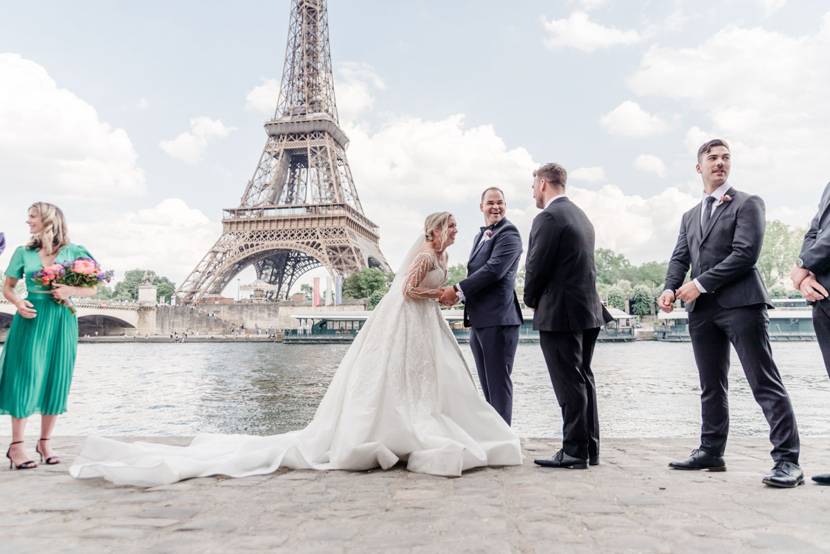 friends and bridemaids with the couple in front of the eiffel tower