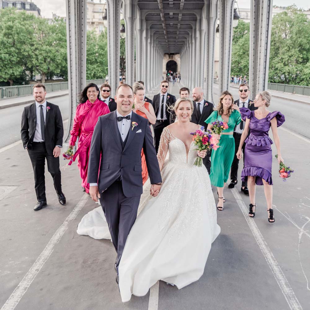 Bride and groom kiss at the bottom of the eiffel tower in Paris