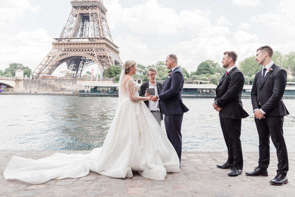 Bride and groom exchanging their rings at the bottom of the eiffel tower in Paris