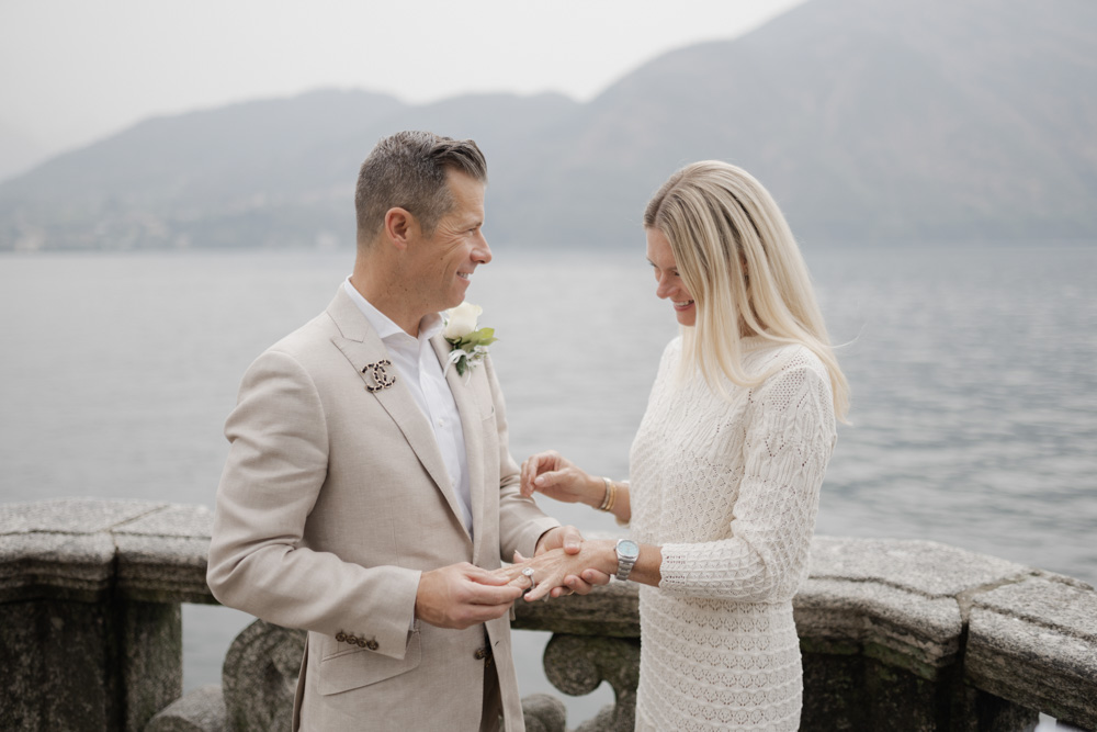 the groom slides the ring to the bride and looking her in the eyes