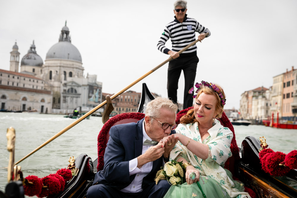 a classical and very romatic kiss on th ehand by the groom