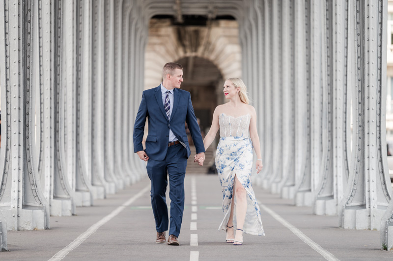 the couple walking under the bridge