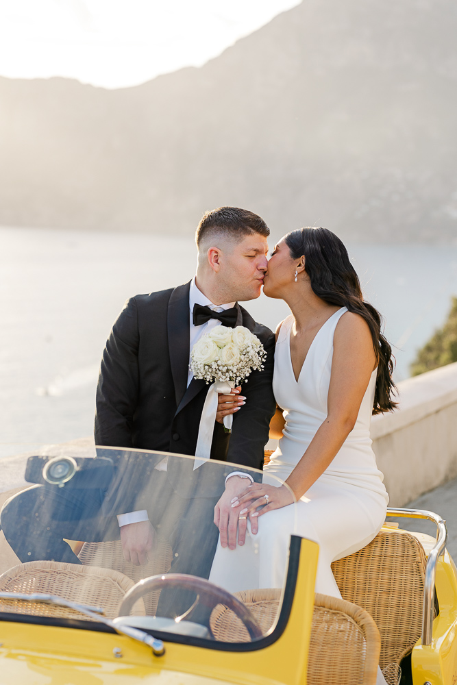A lovely moment of kissing in the vintage yellow car