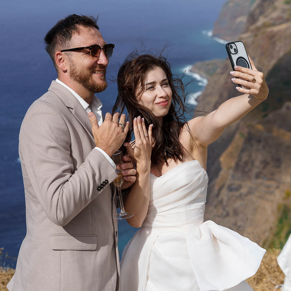 The couple in a funny moment for a selfie with their rings after the ceremony
