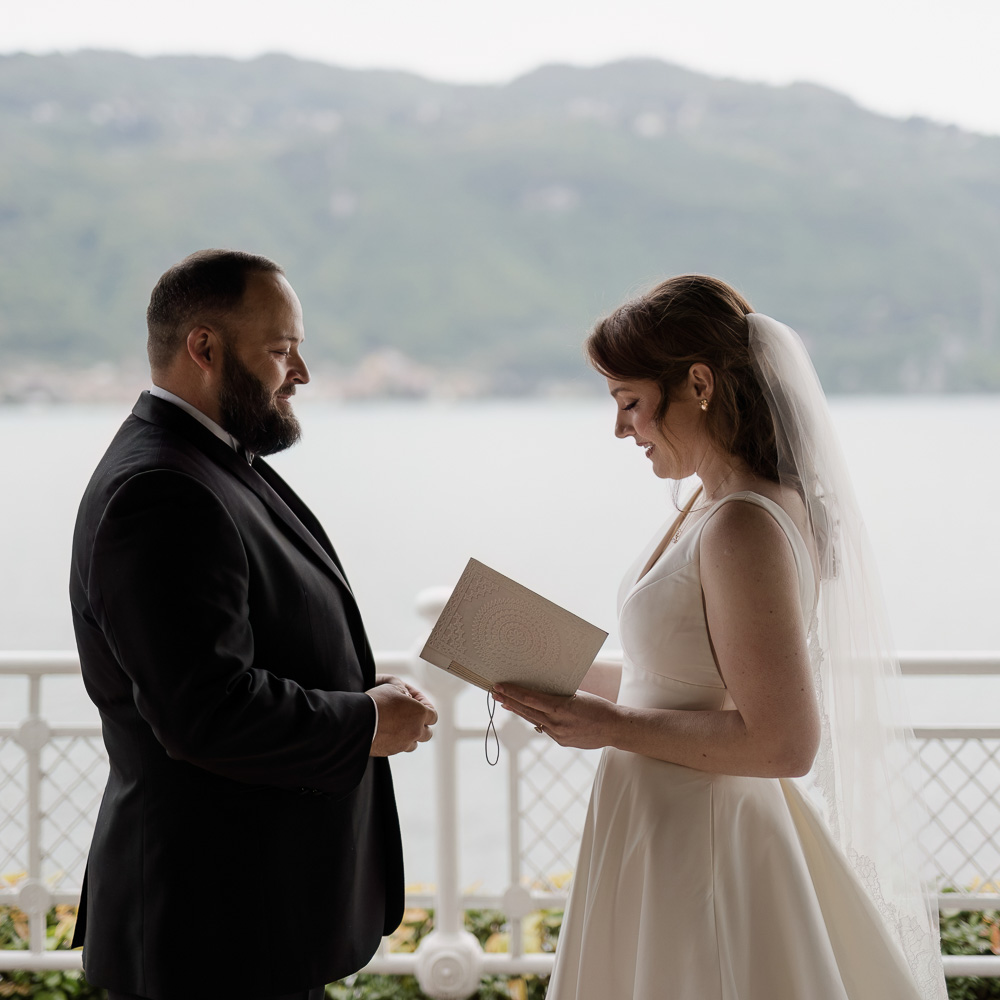 Wedding at Lake Garda-33-001 The couple facing each other during the vows over the lake garda for their weddding