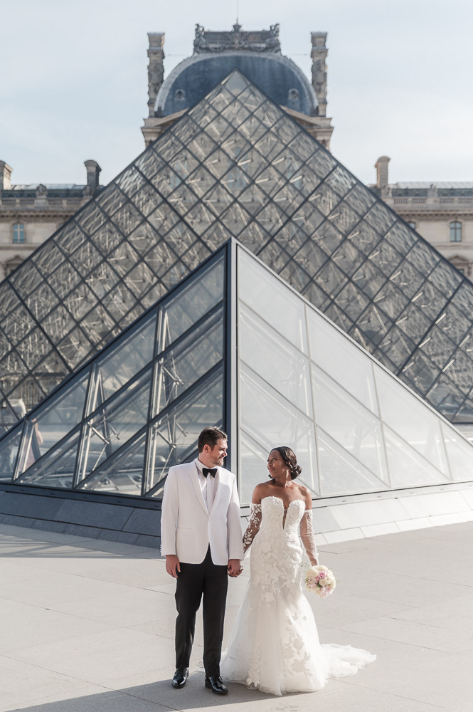 The couple in front of the Louvre Pyramid for their vows renewal