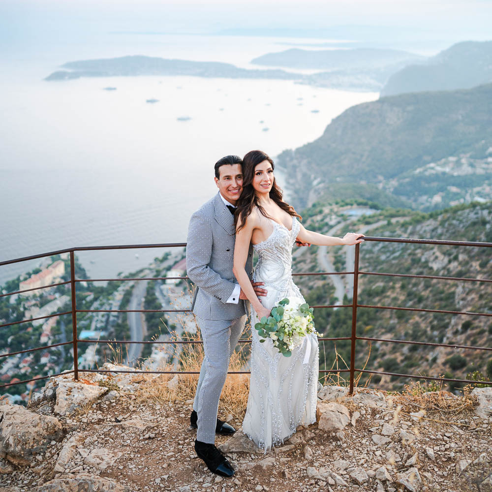 The couple on a balcony for a photo above the Monaco bay
