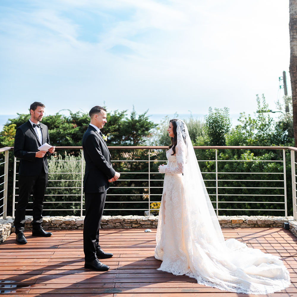 the couple during a wedding ceremony on a private balcony over the see in Monaco