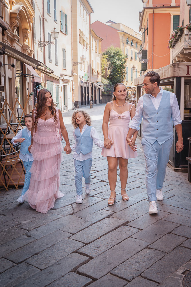 all the family together in siestre levante, walking in the street to enjoy the ceremony