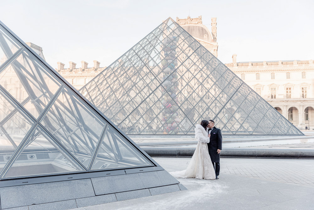 The Pyramid in Winter with snow on the ground and the couple kissing