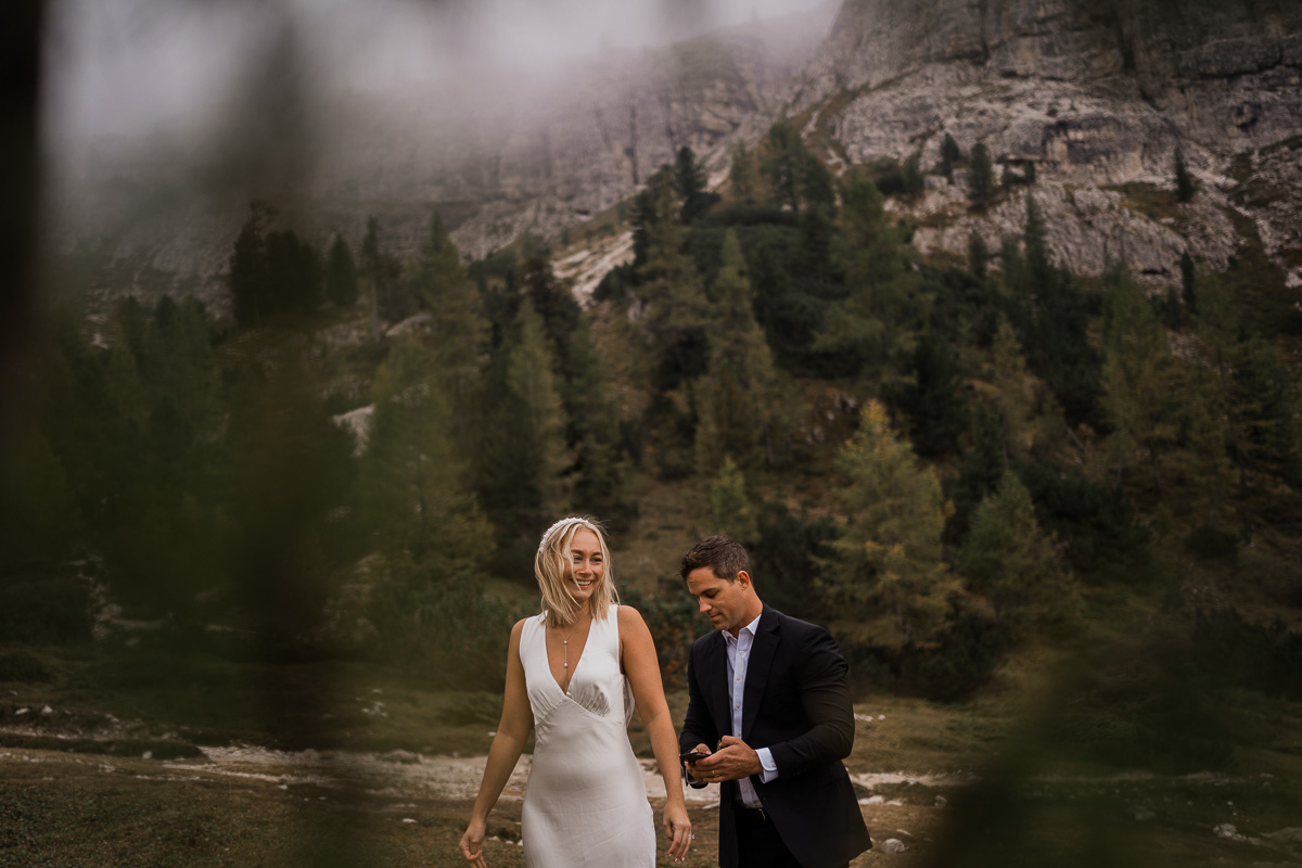 Elopement wedding in Dolomites-01 the groom did a last check of the bride dress before their elopement ceremony