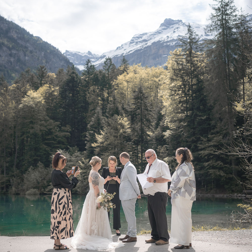 The family around the couple for a ceremony of wedding in Dolomites, Italy