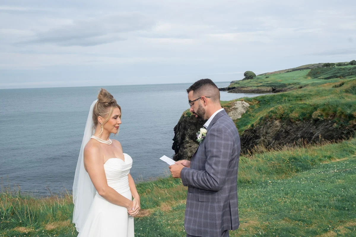 Groom reading vows during Ireland wedding at Black Castle