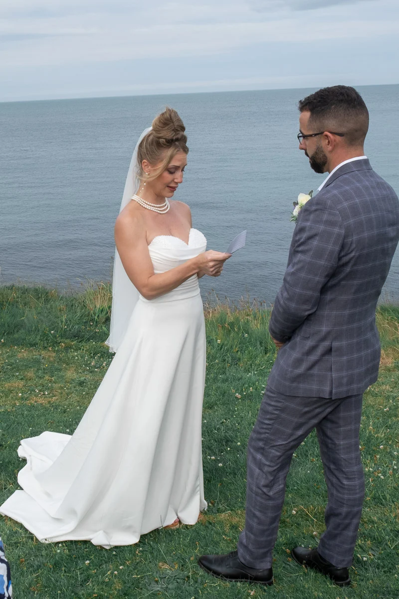 Bride reading vows during Ireland wedding ceremony