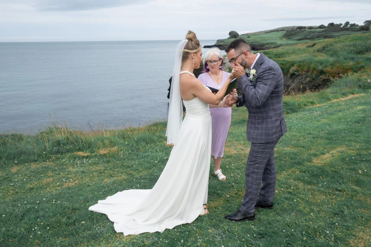 groom kiss the bride hand during the wedding