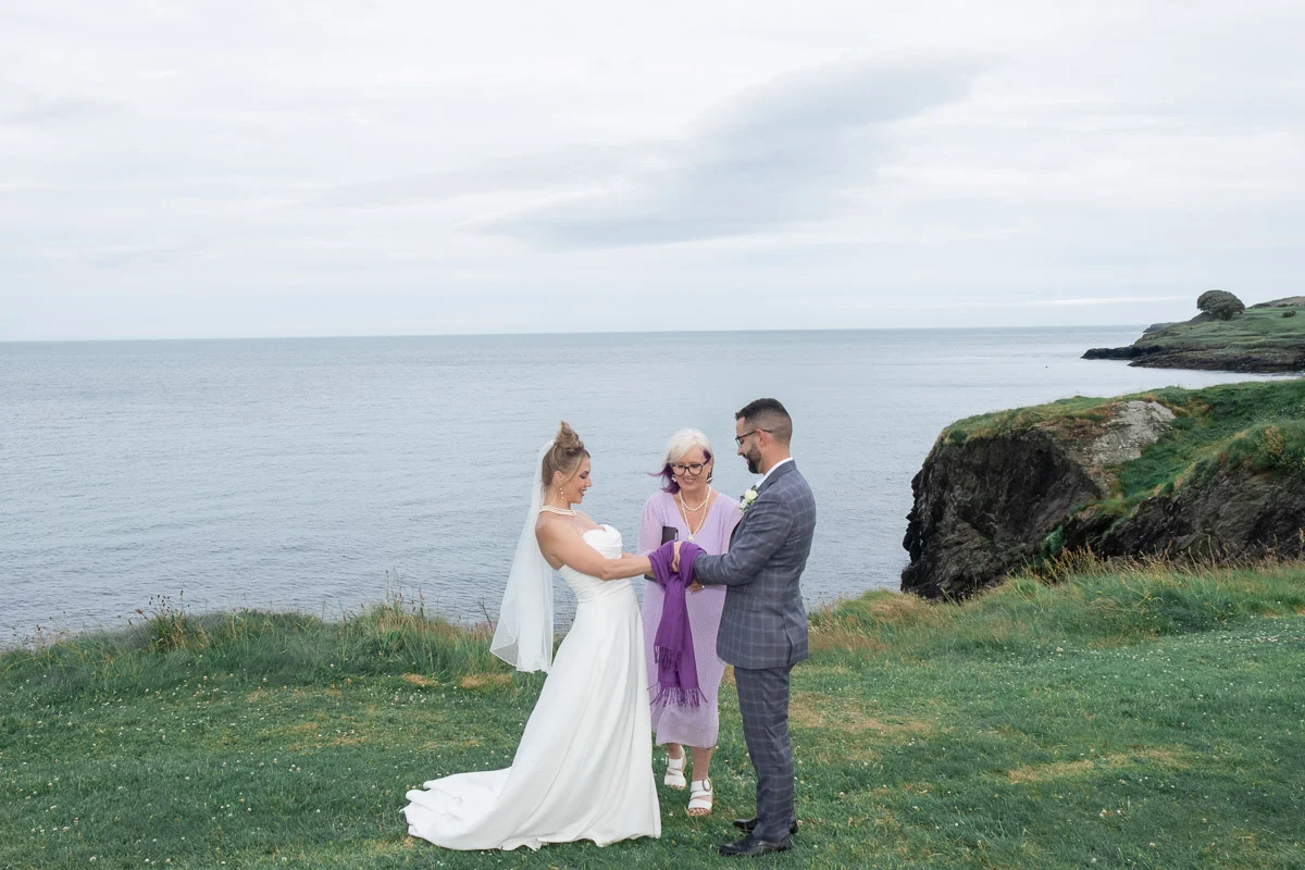 Ireland wedding handfasting ritual with purple ribbon Black Castle Wicklow